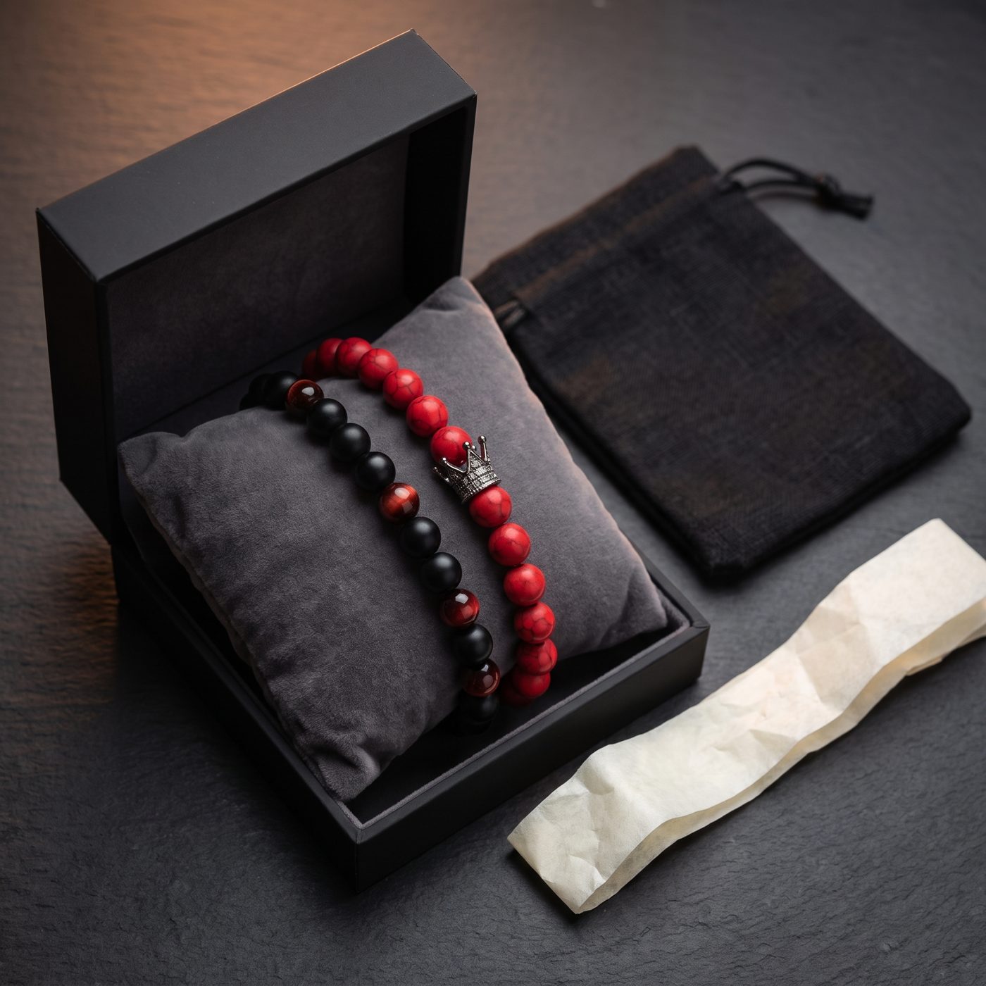 Two bracelets in a black gift box with a linen pouch